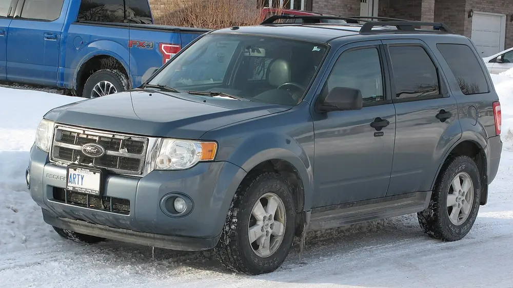 A blue-grey 2010 Ford Escape seen from the front