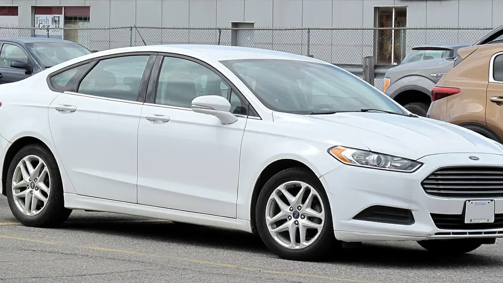 A white 2013 Ford Fusion seen from the front
