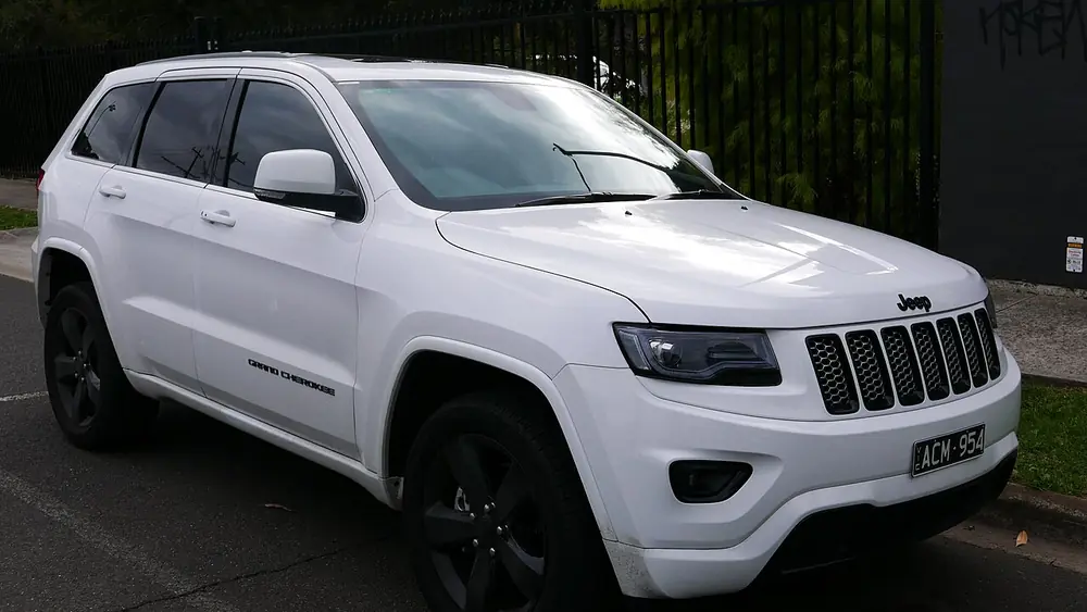 A white 2014 Jeep Grand Cherokee seen from the front