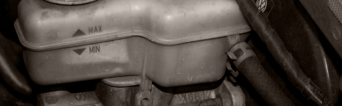 A brake fluid reservoir sitting on top of the master cylinder