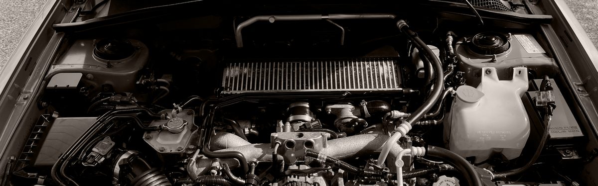 An engine bay with the coolant reservoir holding yellow-green coolant