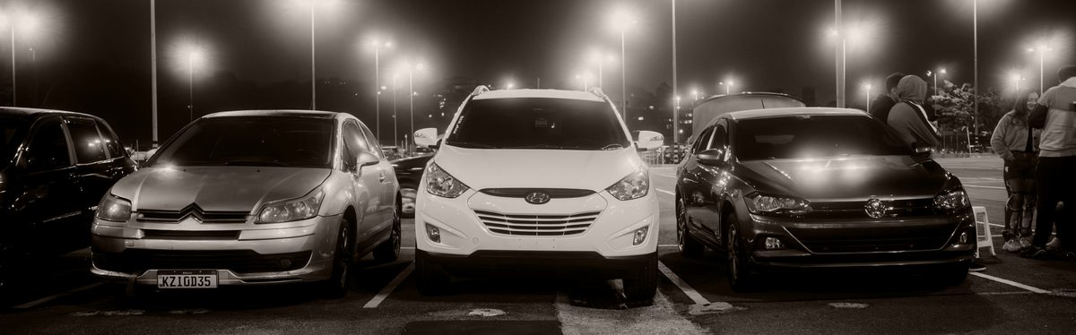 Cars parked overnight in a lit parking lot