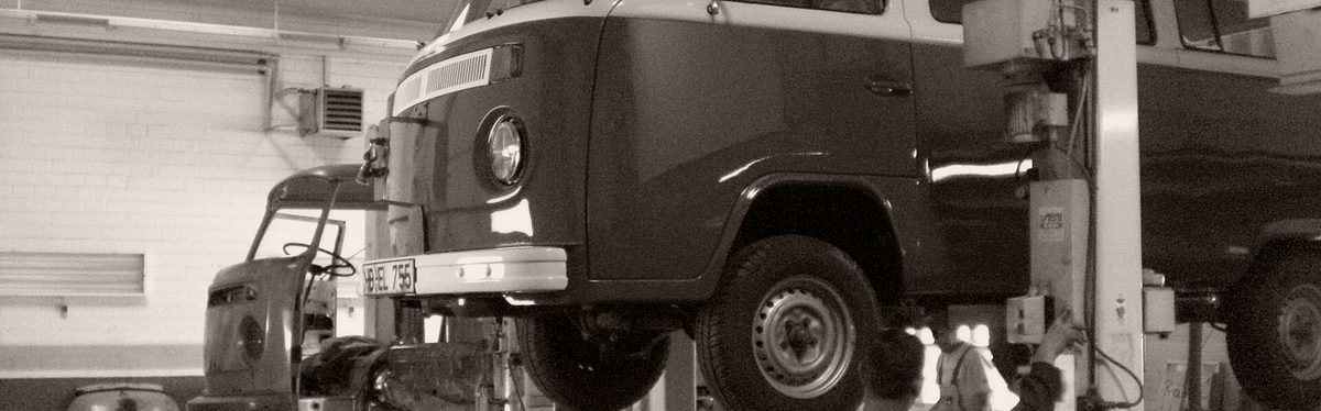 A van raised on a workshop lift