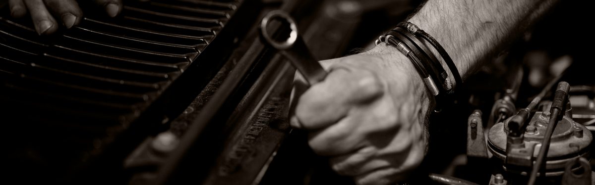 A mechanic's hands working on an engine