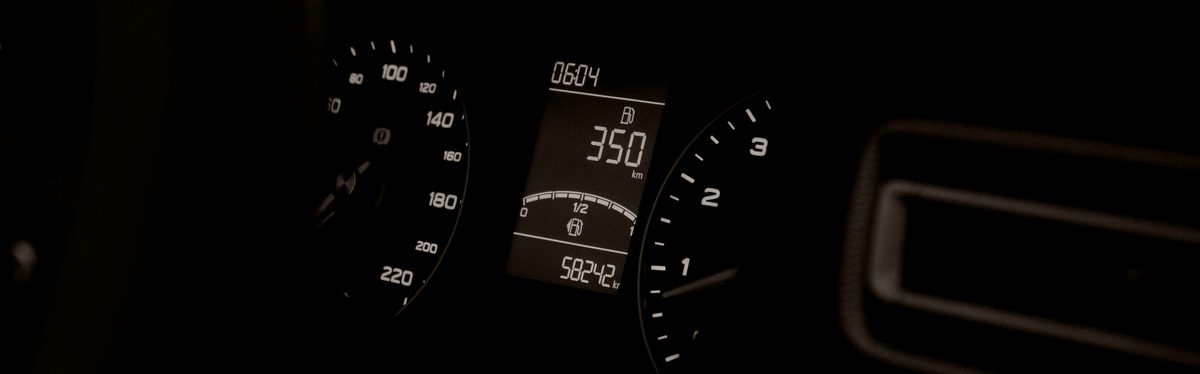 A car instrument cluster with a digital readout between the dials