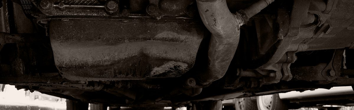 The underside of a car showing the oil pan