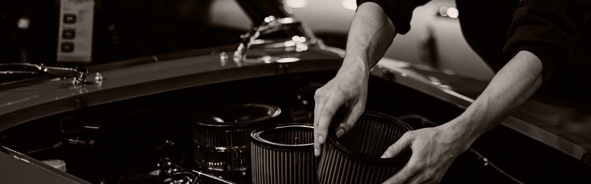 A mechanic leaning into an engine bay