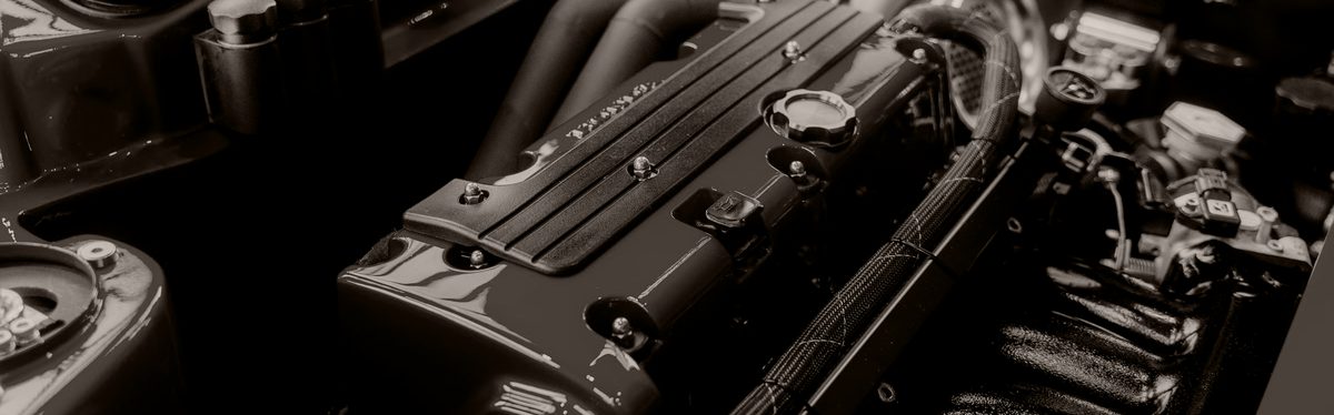 A modern engine bay shot close, its hoses and ducting reading as a pattern