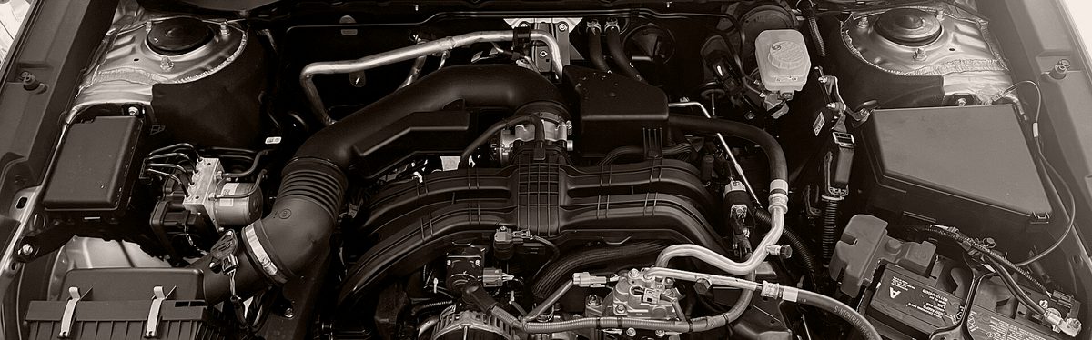 The engine bay of a 2023 Subaru Outback 2.5 with the hood open: the air intake tube, the intake manifold and its hoses