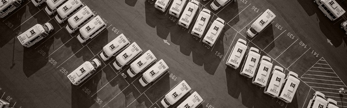 Identical vehicles parked in rows, seen from above