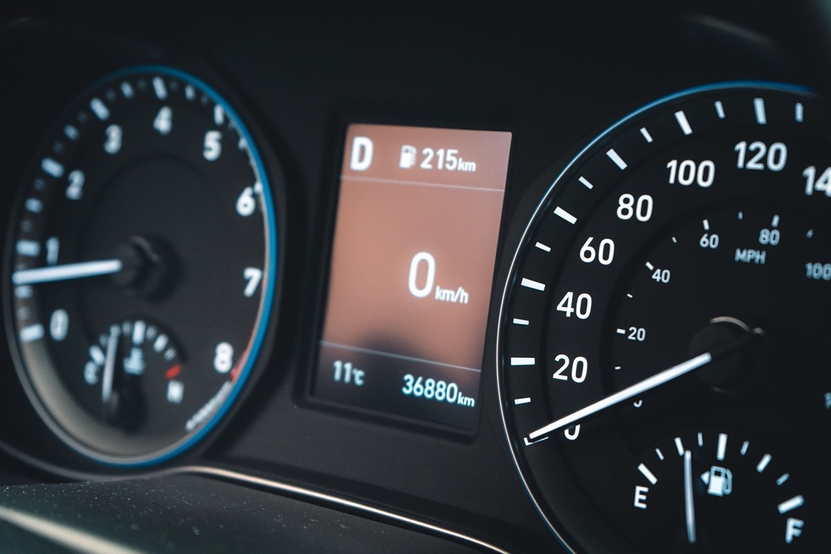 A car instrument cluster with the trip display reading 36,880 km beside the speedometer