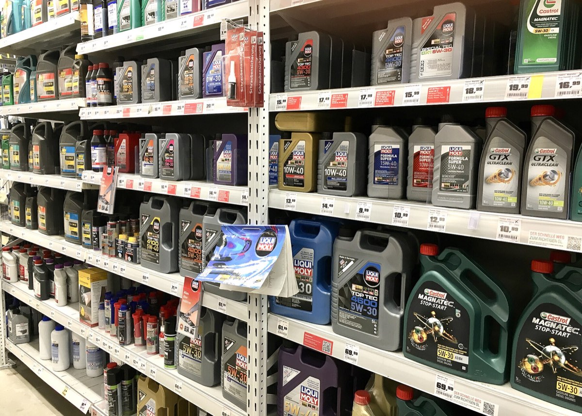Shelves of motor oil bottles from several different manufacturers in a hardware store